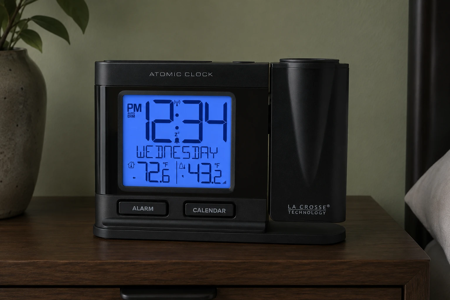 La Crosse 616-41667V2 projection alarm clock on a walnut bedside cabinet — editorial illustration